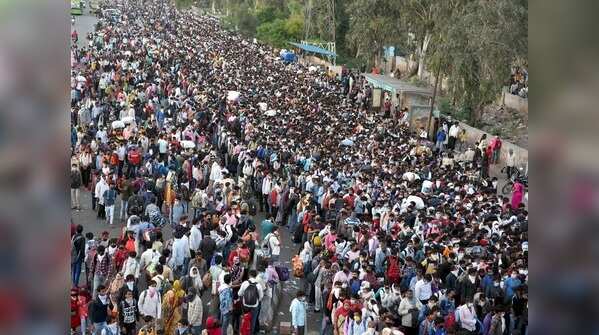 Migrant workers waiting for their busses for their native villages at Anand Vihar Bus Terminal in Delhi