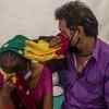A couple from Jhansi wipe away their tears as they wait to get a date for chemotheraphy on April 01, 2020 in New Delhi.