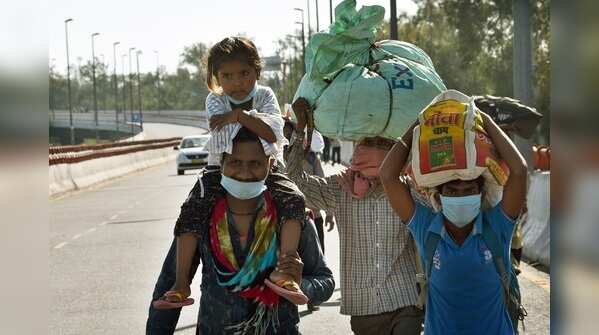 Migrant workers head home on the fourth day of national lockdown at Barapula flyover in Delhi
