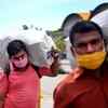 Migrant workers carry their luggage to board a train to Uttar Pradesh at LTT terminus in Mumbai