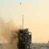 Article image for: An air guided bomb can be seen hitting Al-Sharouk tower as it collapses during an air strike in Gaza.
