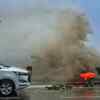 A BMC worker cleans the Gateway Promenade as huge wave lashes due to Cyclone Tauktae in Mumbai on Monday.