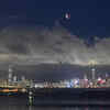 The moon rises over the Victoria Harbour in Hong Kong (AP photo)