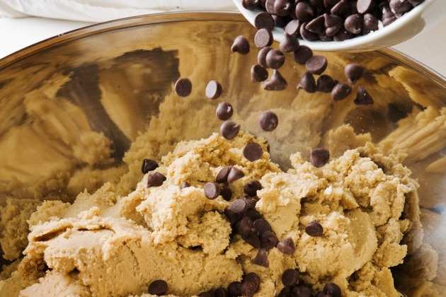 adding-chocolate-chips-to-cookie-dough-picture-id173896352