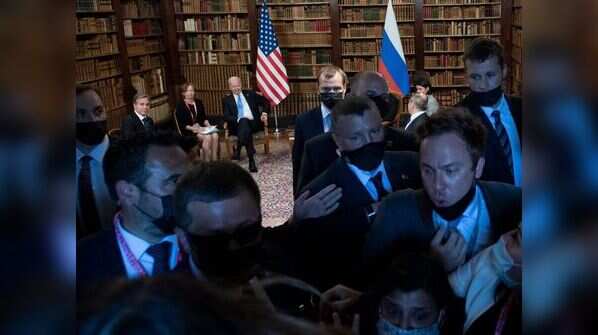 Security personnel pushes the press outside during the summit