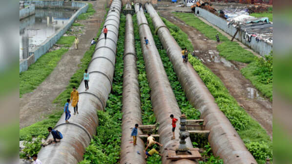 Children playing on pipes