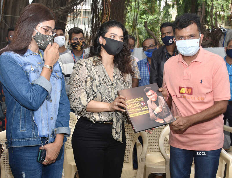 Bollywood actress Kajol distributes raincoats to BMC employees