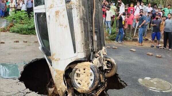 car got stuck after a road caved in Dwarka's Sector 18