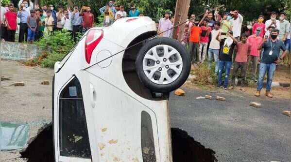 car got stuck after a road caved in Dwarka