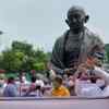 Delhi: Punjab Congress MPs stage a protest in front of Gandhi Statue in the premises of Parliament over three farm laws