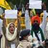 Indian actress Sonia Mann with protesting farmers hold placards and shout slogans as they arrive to a designated area for staging demonstration against the Central government’s recent agricultural reforms at Jantar Mantar