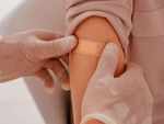 Who is more prone to develop skin reactions from COVID vaccines?