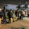 French nationals and their Afghan colleagues line up to board a French military transport plane at Kabul airport on August 17, for evacuation from Afghanistan after the Taliban's stunning military takeover of the country (AFP)