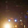 Article image for: A police officer patrols past woman walking along <i class="tbold">bourbon street</i>.