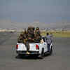 Members of the Taliban Badri 313 military unit ride a vehicle on the runway of the airport in Kabul on Tuesday