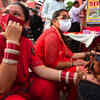 Women applying mehendi