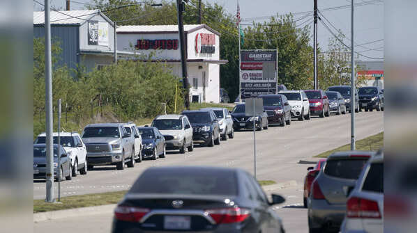 Vehicles line up on the road leading to Mansfield ISD Center for the Performing Arts, in Texas, where children were evacuated following the school shooting in Arlington Wednesday.