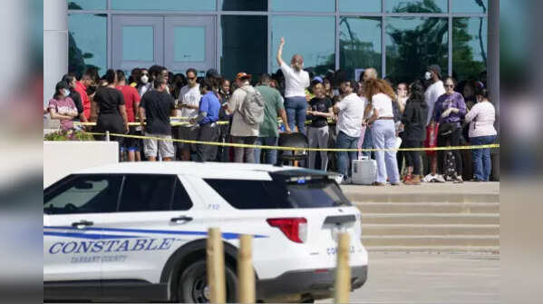 Families being addressed by an unidentified person at the Mansfield ISD Center, as they wait to be reunited with their children Wednesday.