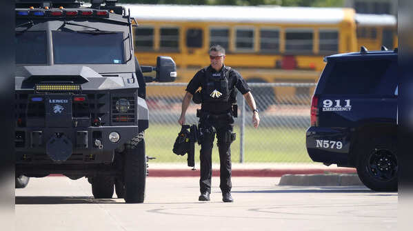 A law enforcement officer in the parking lot of Timberview High School after the shooting inside.