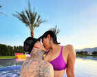Bikini-clad Kourtney Kardashian shares a passionate kiss with fiancé Travis Barker in the pool