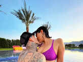 Bikini-clad Kourtney Kardashian shares a passionate kiss with fiancé Travis Barker in the pool
