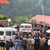 Coonoor: People gather to pay homage to CDS General Bipin Rawat, his wife, and army personnel outside Madras Regimental Centre as the convoy with mortal remains leave for Sulur Air Force Station