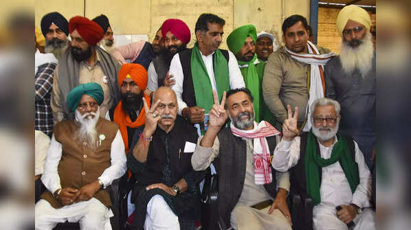Farmer leaders show victory sign
