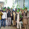 Farmers hold flags and show victory sign