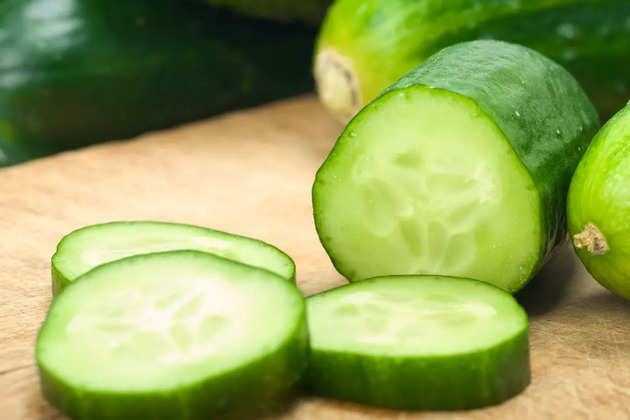 sliced-up-cucumbers-on-wooden-board-picture-id182888377