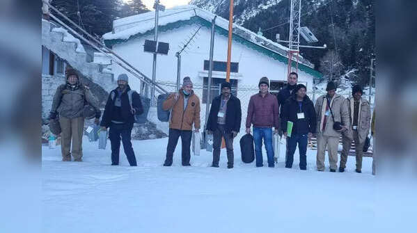 Poll officials brave harsh weather to reach booths