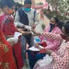 People being thermally scanned, given hand sanitizer and gloves before entering the polling booth in Khatima town of Udham Singh Nagar.