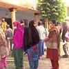 People queue up at Montessori School polling booth in Lucknow as they await their turn to cast vote in the fourth phase of UP polls