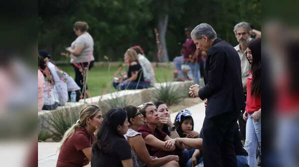 Archbishop of San Antonio, Gustavo Garcia Seller comforts families outside of the Civic Center following the deadly school shooting at Robb Elementary School, in Uvalde, Texas, Tuesday.