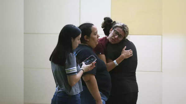 People react outside the Civic Center following the deadly school shooting at Robb Elementary School in Uvalde, Texas, May 24, 2022.