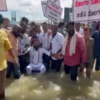 Mohammed Haris Nalapad, President, Karnataka Pradesh Youth Congress Committee floats using an inflated rubber tube on a waterlogged road in Bengaluru to protest against the state govt demanding a solution to severe waterlogging witnessed in the city.