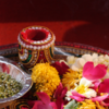 Do the pooja of the cow dung with water, moli, chawal, <i class="tbold">roli</i>, and jhuwar.