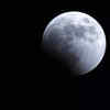 The earth's shadow starts to cover the moon during a lunar eclipse in Yokohama near Tokyo
