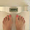 ​Focusing on the number on the weighing scale