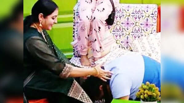 Rupesh Rajanna touches his wife's feet as a gesture of love and gratitude