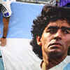 Argentina fan displays a banner with an image of Diego Maradona inside the stadium before the match