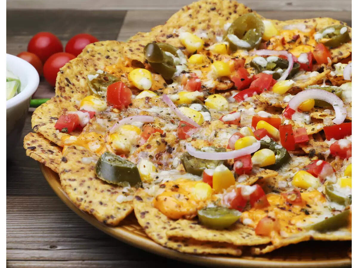 Cheesy Quinoa Nachos Recipe: How to make Cheesy Quinoa Nachos Recipe at Home | Homemade Cheesy Quinoa Nachos Recipe at Home - Times Food