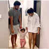 The mother-father walking holding Ziana’s hands
