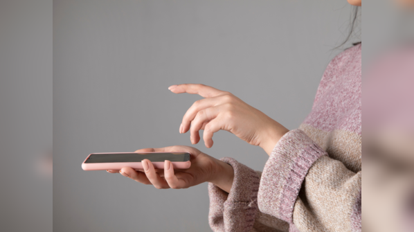 Holding phone with one hand and using index finger of another hand