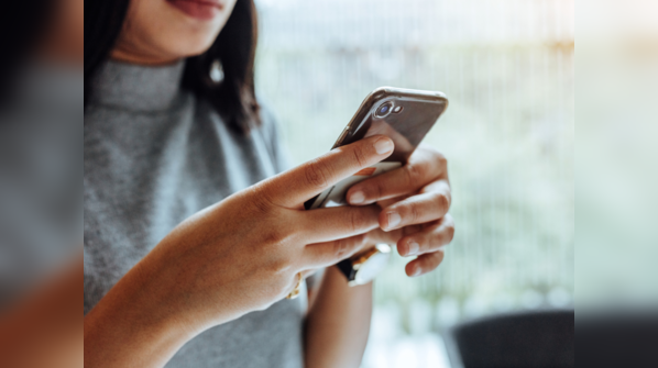 Holding phone with both hands and using both thumbs