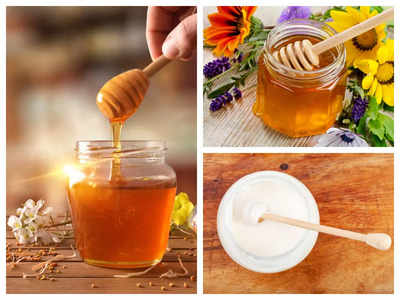 A honey jar with a spoon for honey and different nuts on white b