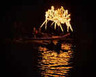Boats and torches light up the river at COEP's Regatta