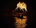 Boats and torches light up the river at COEP's Regatta