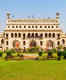 What makes Bara Imambara a must-visit attraction in Lucknow?