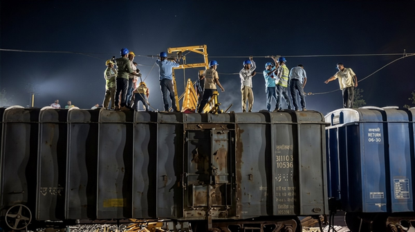 Crane collapses on stationary goods trains