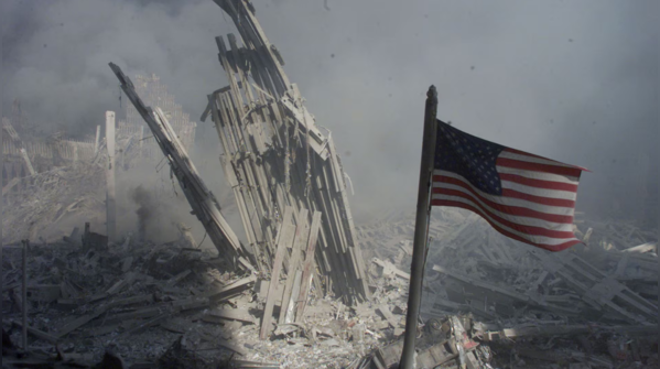 American flag flies amid debris
